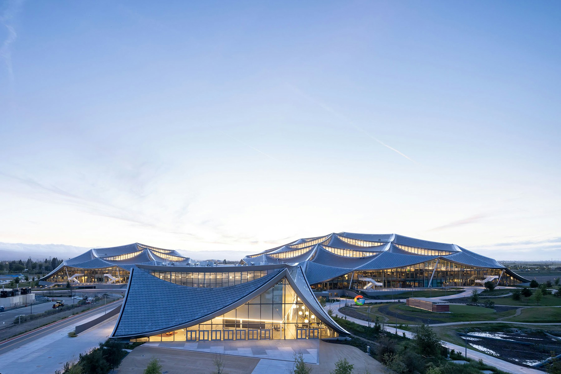 A view of the Bay View campus with the events center in the foreground and a Google brandmark sculpture. Photo: Iwan Baan.
