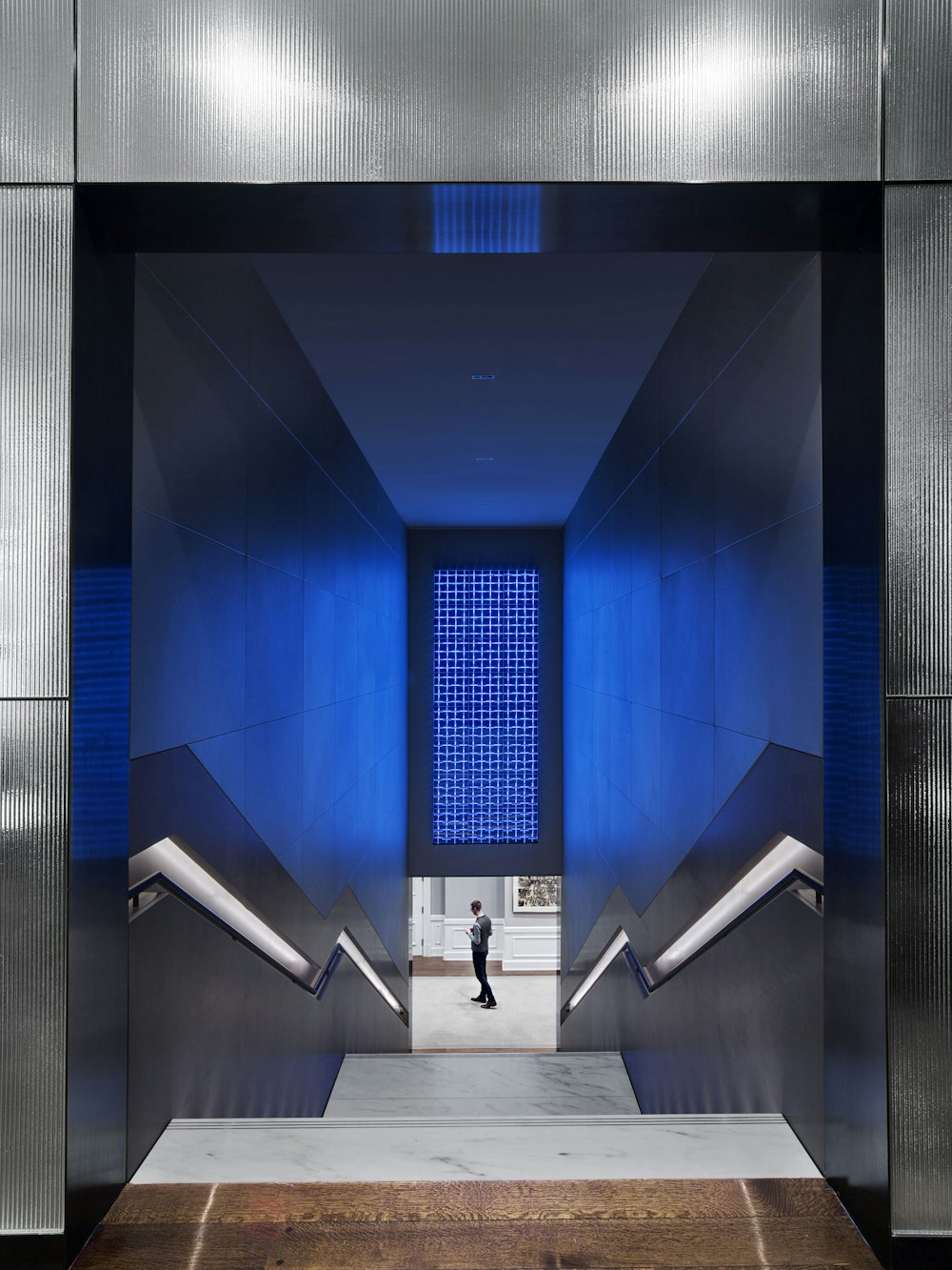 Stair inserted between amenities floors with programmable LED art installation