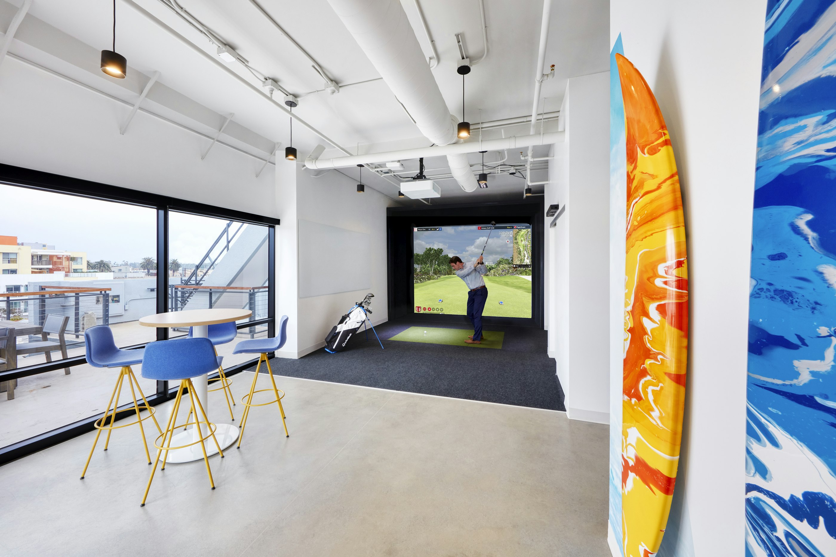 The golf simulator allows employees and clients alike to play 18 holes without leaving the office.