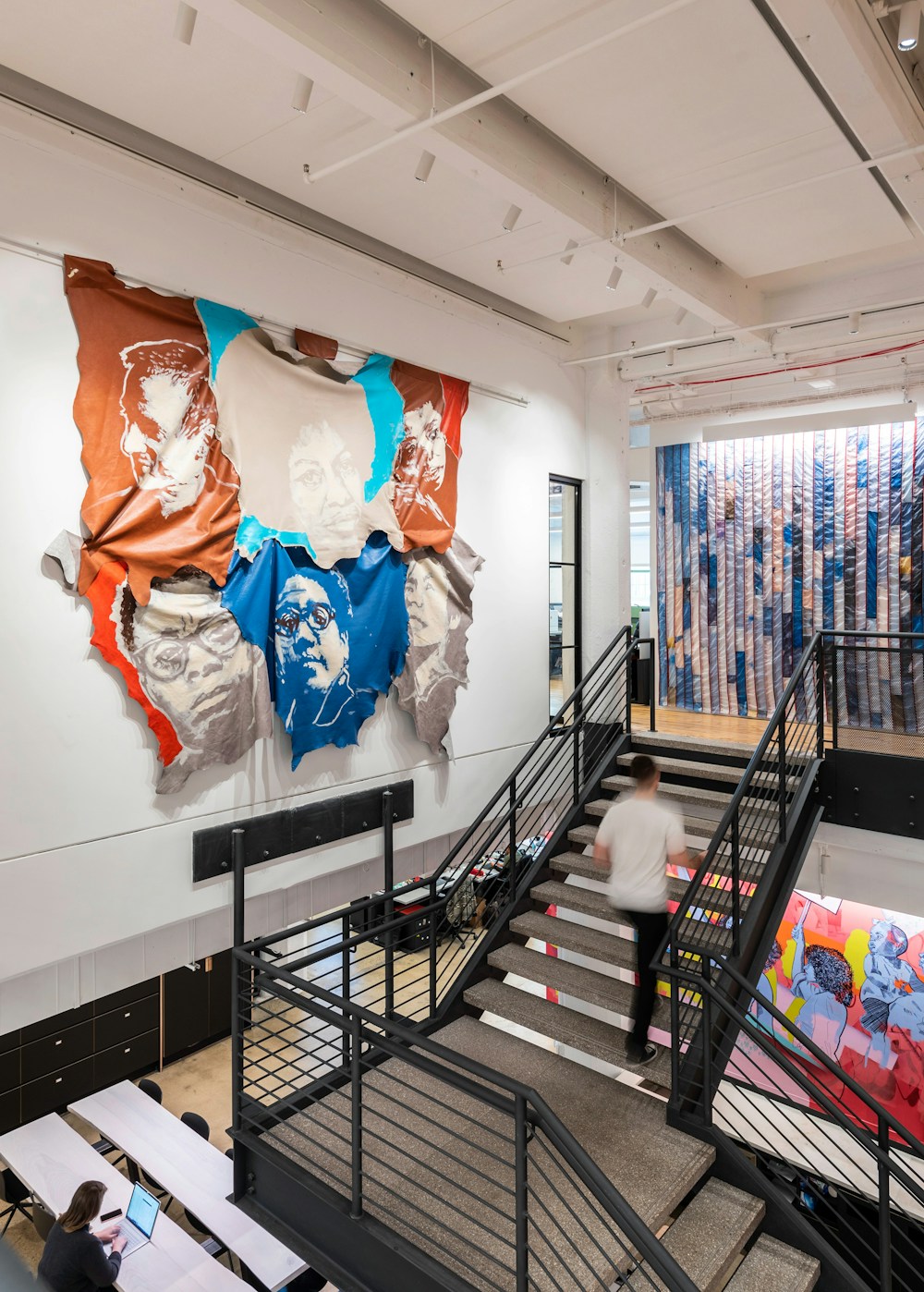 Art surrounds the central stair in many scales and mediums