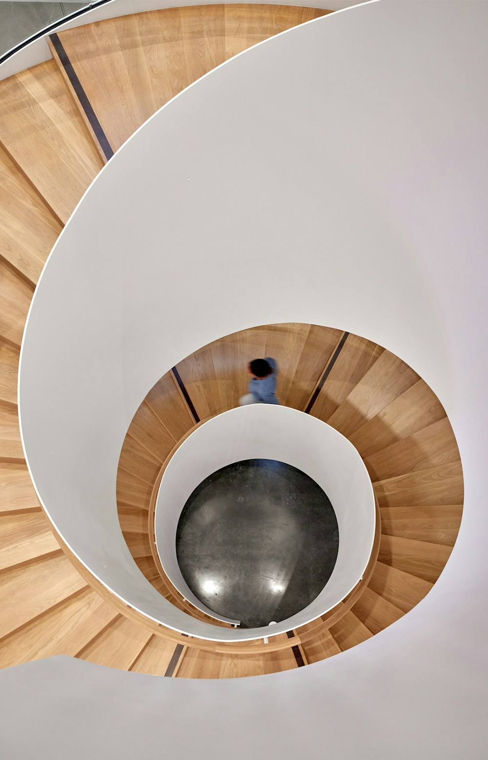 The central grand spiraling stair connects all three work floors.