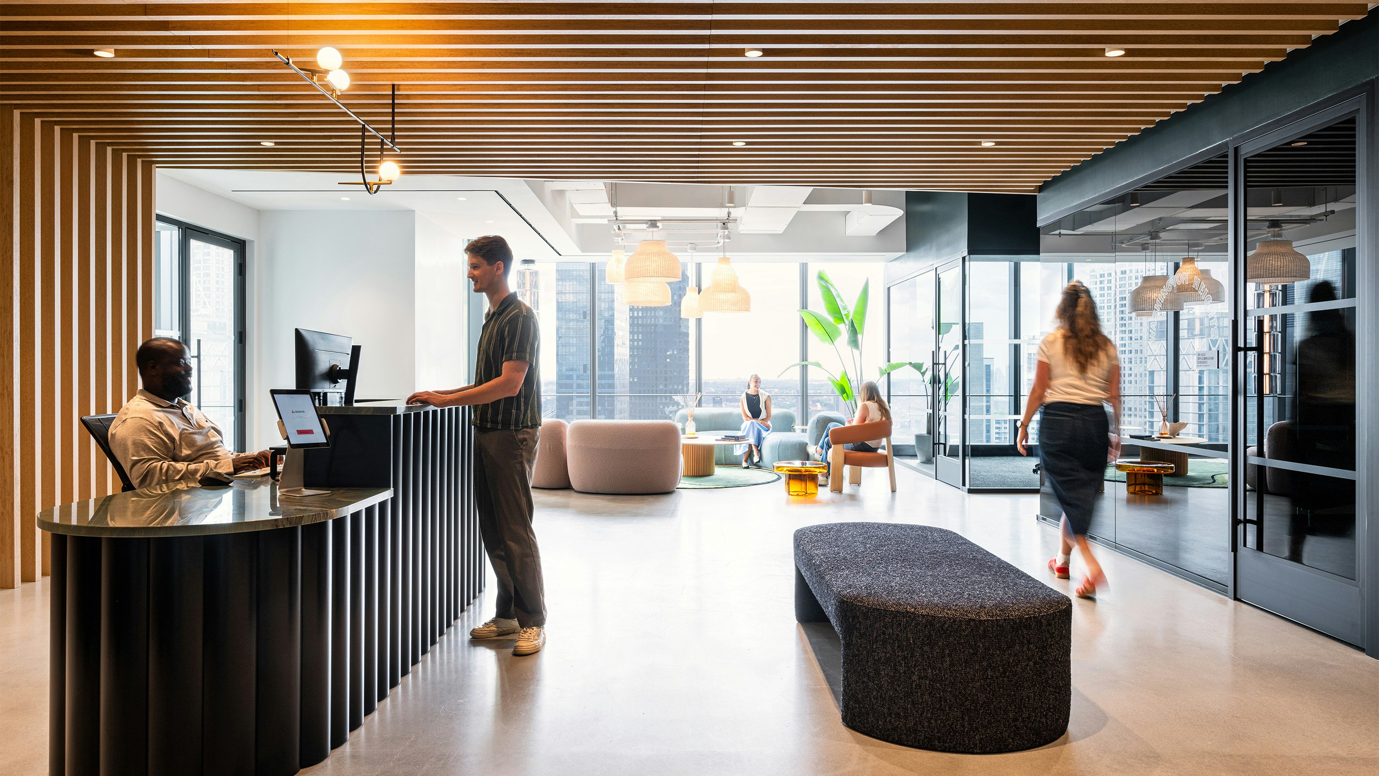 Asana reception desk with stylized logo hung above it.