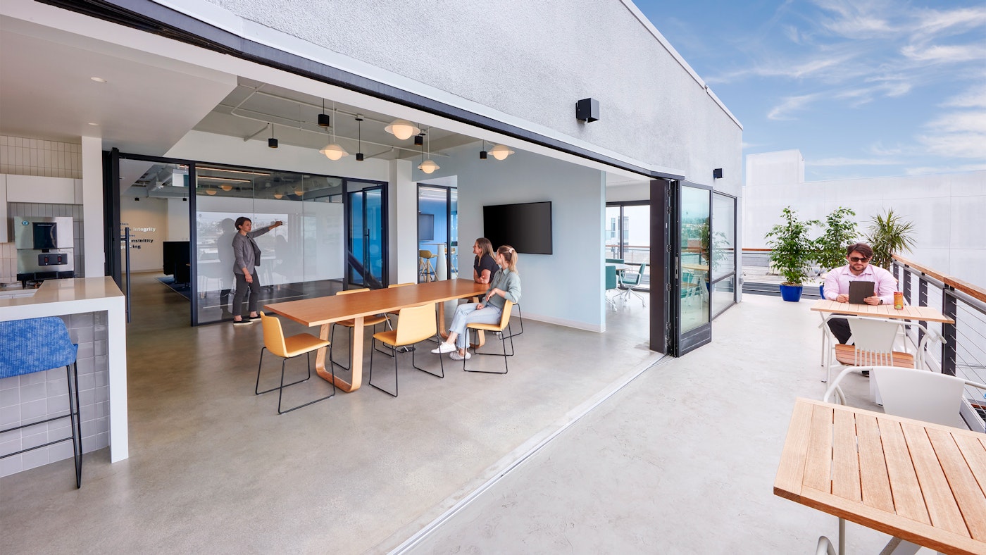A nana wall connects an indoor collaboration area with an open air terrace
