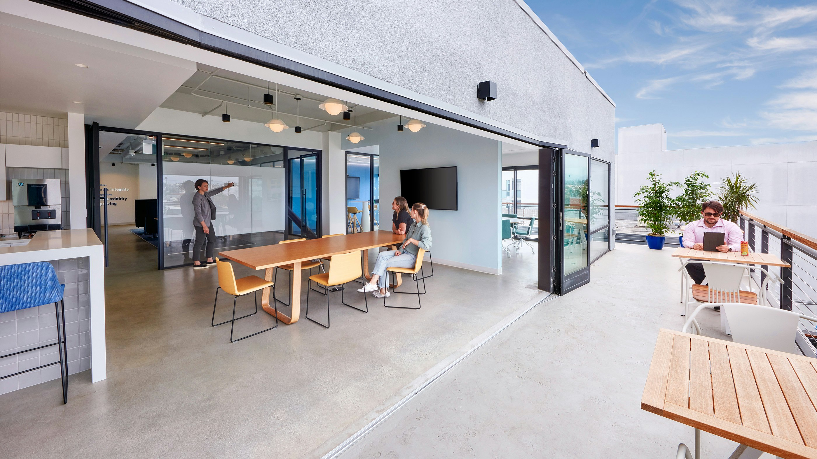 A nana wall connects an indoor collaboration area with an open air terrace